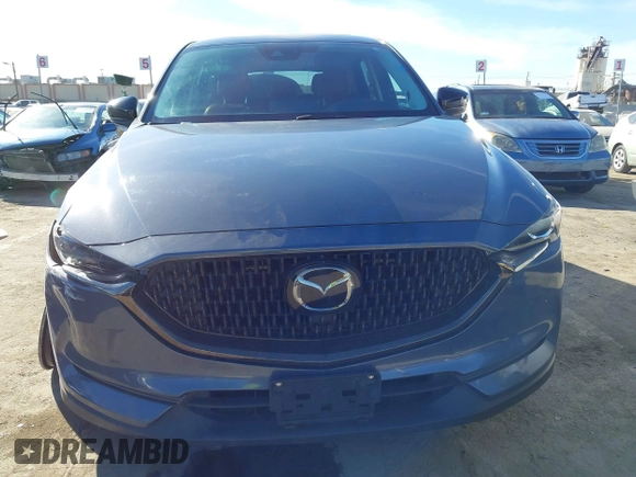 2021 Mazda CX-5 Touring with VIN JM3KFBCM9M0434433, listed as a IAAI auction lot 41425112 with 57,527 mi miles. Bid and sale history available at carsss.com. Image 13.