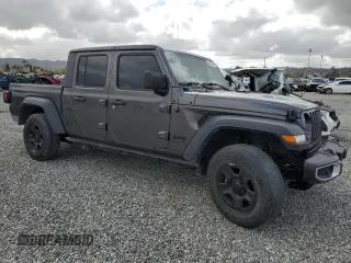 2023 Jeep Gladiator Freedom with VIN 1C6JJTAG9PL557861, listed as a Copart auction lot 50452955 with 44,716 mi miles and Salvage title. Bid and sale history available at DreamBid. Image 4.
