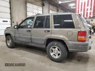 1998 Jeep Grand Cherokee Laredo with VIN 1J4GZ58S3WC207166, listed as a Copart auction lot 84243704 with 124,084 mi miles and Salvage Title. Bid and sale history available at carsss.com. Image 2.