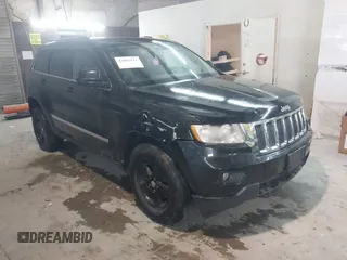 2013 Jeep Grand Cherokee Laredo with VIN 1C4RJEAG0DC504002, listed as a IAAI auction lot 42055122 with 242,170 mi miles. Bid and sale history available at carsss.com. Image 1.