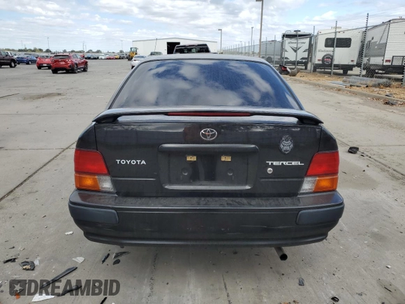 1996 Toyota Tercel DX z VIN JT2AC52LXT0157984, wystawiony jako Copart lot #76524974 z przebiegiem Nie podano mil oraz Szkoda całkowita • Salvage title. Historia ofert i sprzedaży dostępna na DreamBid. Obrazek 6.