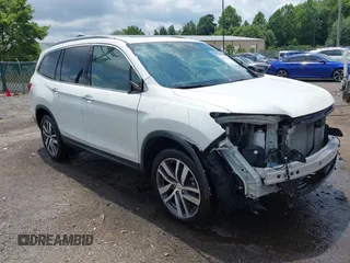 2018 Honda Pilot Touring with VIN 5FNYF6H91JB028626, listed as a IAAI auction lot 42660688 with 100,490 mi miles and . Bid and sale history available at DreamBid. Image 1.