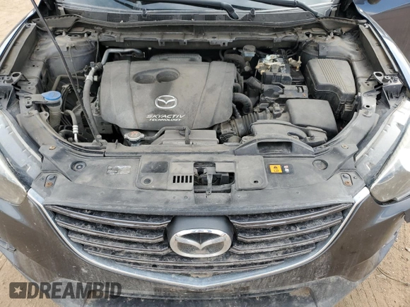 2016 Mazda CX-5 Grand Touring z VIN JM3KE4DY0G0633861, wystawiony jako Copart lot #47748645 z przebiegiem 112 219 mil mil oraz Szkoda całkowita • Salvage title. Historia ofert i sprzedaży dostępna na DreamBid. Obrazek 14.