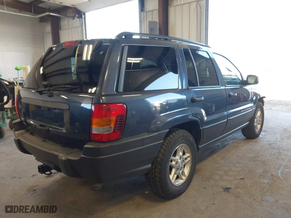 2003 Jeep Grand Cherokee Laredo with VIN 1J4GW48S33C539977, listed as a IAAI auction lot 42027703 with 100,534 mi miles. Bid and sale history available at carsss.com. Image 4.