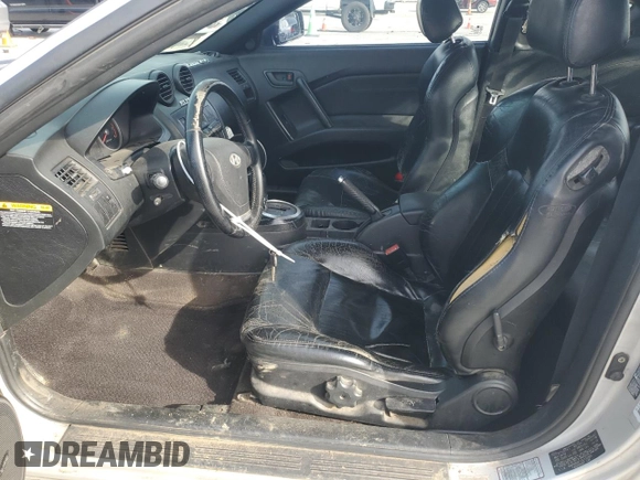 2003 Hyundai Tiburon GT z VIN KMHHN65F13U102985, wystawiony jako Copart lot #45294325 z przebiegiem 326 919 mil mil oraz Szkoda całkowita • Salvage title. Historia ofert i sprzedaży dostępna na DreamBid. Obrazek 7.