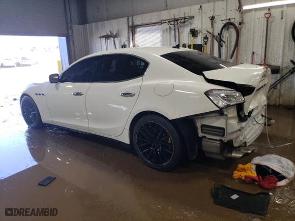2014 Maserati Ghibli S Q4 with VIN ZAM57RTA4E1117703, listed as a Copart auction lot 48754515 with 104,284 mi miles and Salvage Title. Bid and sale history available at carsss.com. Image 2.