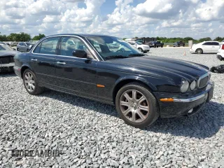 2004 Jaguar XJ with VIN SAJEA71C14SG10928, listed as a Copart auction lot 51202785 with 164,300 mi miles and Salvage Title. Bid and sale history available at carsss.com. Image 4.