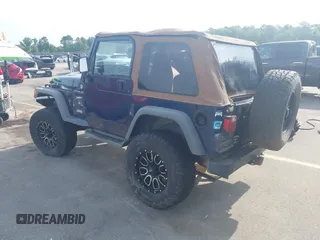 2002 Jeep Wrangler Sport with VIN 1J4FA49S72P729703, listed as a IAAI auction lot 42468446 with 164,342 mi miles and . Bid and sale history available at DreamBid. Image 3.