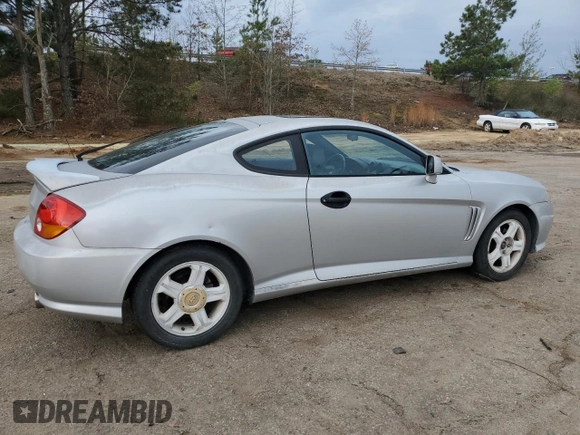 2003 Hyundai Tiburon GT z VIN KMHHN65F13U013420, wystawiony jako Copart lot #51234495 z przebiegiem 230 612 mil mil oraz Szkoda całkowita • Salvage title. Historia ofert i sprzedaży dostępna na DreamBid. Obrazek 3.