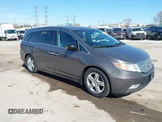 2012 Honda Odyssey Touring with VIN 5FNRL5H9XCB077351, listed as a IAAI auction lot 42045976 with 146,290 mi miles and . Bid and sale history available at DreamBid. Image 1.