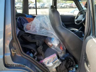1999 Jeep Cherokee Sport with VIN 1J4FT68S1XL577603, listed as a Copart auction lot 54216115 with 180,128 mi miles and Salvage title. Bid and sale history available at DreamBid. Image 11.