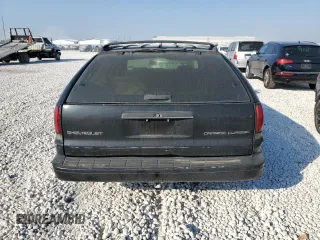 1996 Chevrolet Caprice with VIN 1G1BL82P2TR106404, listed as a Copart auction lot 74213214 with 156,588 mi miles and Salvage title. Bid and sale history available at DreamBid. Image 6.