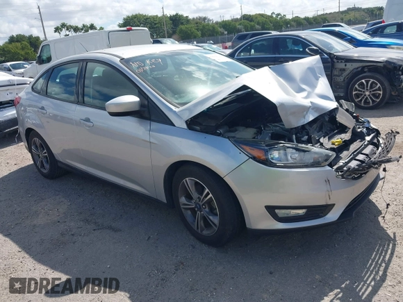 2018 Ford Focus SE z VIN 1FADP3FE3JL220529, wystawiony jako IAAI lot #41564216 z przebiegiem 16 883 mil mil oraz . Historia ofert i sprzedaży dostępna na DreamBid. Obrazek 1.