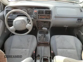 2000 Chevrolet Tracker z VIN 2CNBE13C4Y6920783, wystawiony jako Copart lot #82619854 z przebiegiem 96 620 mil mil oraz Czysty tytuł • Clean title. Historia ofert i sprzedaży dostępna na DreamBid. Obrazek 8.