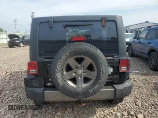 2015 Jeep Wrangler Unlimited Freedom with VIN 1C4BJWDG4FL568601, listed as a Copart auction lot 64041415 with 128,874 mi miles and Salvage title. Bid and sale history available at DreamBid. Image 6.