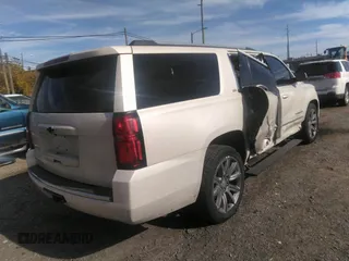 2015 Chevrolet Suburban LTZ with VIN 1GNSKKKC0FR551031, listed as a IAAI auction lot 40694559 with 184,261 mi miles. Bid and sale history available at carsss.com. Image 4.