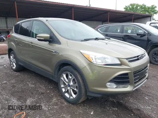2013 Ford Escape SEL z VIN 1FMCU9H9XDUB61880, wystawiony jako IAAI lot #42271136 z przebiegiem 115 837 mil mil oraz . Historia ofert i sprzedaży dostępna na DreamBid. Obrazek 1.