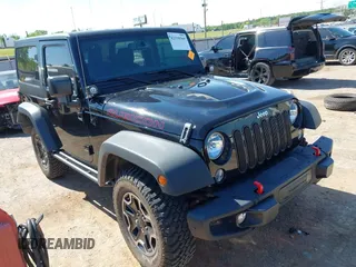 2015 Jeep Wrangler Rubicon Hard Rock z VIN 1C4BJWCG1FL610028, wystawiony jako IAAI lot #42318569 z przebiegiem 48 627 mil mil oraz . Historia ofert i sprzedaży dostępna na DreamBid. Obrazek 1.
