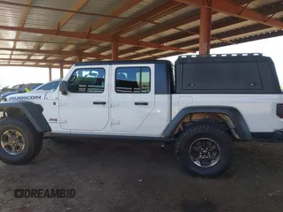 2022 Jeep Gladiator Rubicon with VIN 1C6JJTBM6NL145009, listed as a IAAI auction lot 42134143 with 59,438 mi miles and . Bid and sale history available at DreamBid. Image 14.