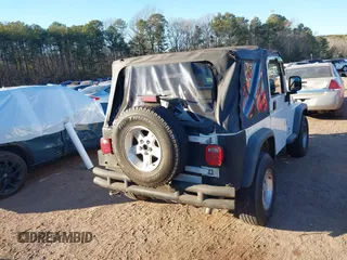 2004 Jeep Wrangler Sport Right Hand Drive with VIN 1J4F449S74P732854, listed as a IAAI auction lot 41408316 with 112,064 mi miles. Bid and sale history available at carsss.com. Image 16.