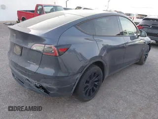 2023 Tesla Model Y Long Range with VIN 7SAYGDEE1PA053683, listed as a IAAI auction lot 42124517 with 32,295 mi miles. Bid and sale history available at carsss.com. Image 4.