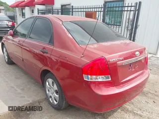 2009 Kia Spectra EX with VIN KNAFE221195606045, listed as a IAAI auction lot 42128548 with 124,577 mi miles. Bid and sale history available at carsss.com. Image 3.