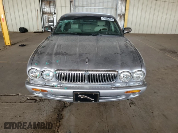 2000 Jaguar XJ with VIN SAJDA25B8YMF04079, listed as a Copart auction lot 50592595 with 131,647 mi miles and Salvage title. Bid and sale history available at DreamBid. Image 5.