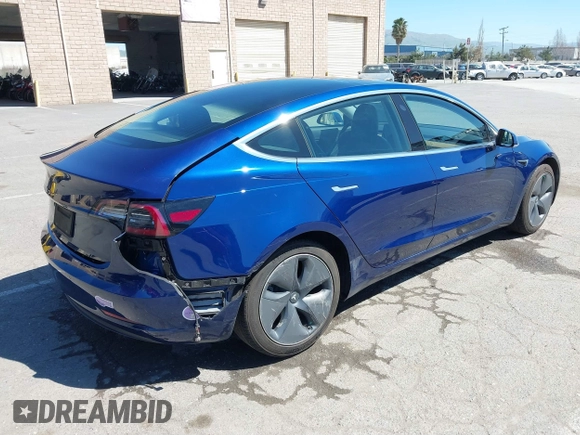 2019 Tesla Model 3 Mid Range with VIN 5YJ3E1EA0KF425079, listed as a IAAI auction lot 41871022 with 61,684 mi miles and . Bid and sale history available at DreamBid. Image 4.