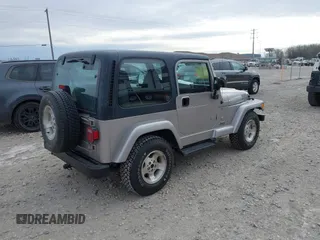 2001 Jeep Wrangler Sport z VIN 1J4FA49S31P349269, wystawiony jako IAAI lot #41427014 z przebiegiem 112 421 mil mil oraz . Historia ofert i sprzedaży dostępna na DreamBid. Obrazek 4.