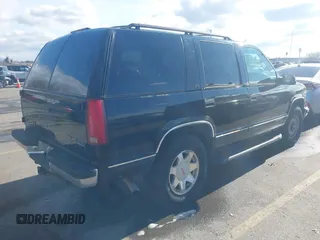 1997 GMC Yukon with VIN 1GKEK13R3VJ759103, listed as a IAAI auction lot 41726127 with 218,500 mi miles. Bid and sale history available at carsss.com. Image 4.