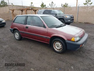 1987 Honda Civic z VIN JHMEC3427HS028239, wystawiony jako IAAI lot #41728725 z przebiegiem 113 710 mil mil oraz . Historia ofert i sprzedaży dostępna na DreamBid. Obrazek 1.
