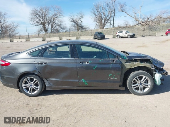 2016 Ford Fusion Titanium Hybrid с VIN 3FA6P0RU8GR266488, выставлен на аукционе IAAI как лот 41903919 с пробегом 74 927 миль миль и . История ставок и продаж доступна на DreamBid. Изображение 14.