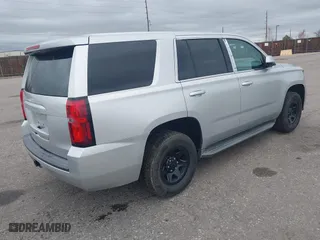 2015 Chevrolet Tahoe Commercial with VIN 1GNSK2ECXFR681555, listed as a IAAI auction lot 41975359 with 126,785 mi miles. Bid and sale history available at carsss.com. Image 4.
