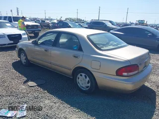 1999 Mazda 626 ES z VIN 1YVGF22C5X5811946, wystawiony jako IAAI lot #41970165 z przebiegiem 126 709 mil mil oraz . Historia ofert i sprzedaży dostępna na DreamBid. Obrazek 3.