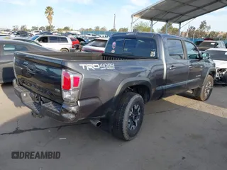 2021 Toyota Tacoma SR5 z VIN 3TMDZ5BN6MM110938, wystawiony jako IAAI lot #41838703 z przebiegiem 67 680 mil mil oraz . Historia ofert i sprzedaży dostępna na DreamBid. Obrazek 4.