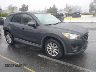 2016 Mazda CX-5 Touring z VIN JM3KE2CY0G0631291, wystawiony jako IAAI lot #41920510 z przebiegiem 191 489 mil mil oraz . Historia ofert i sprzedaży dostępna na DreamBid. Obrazek 1.