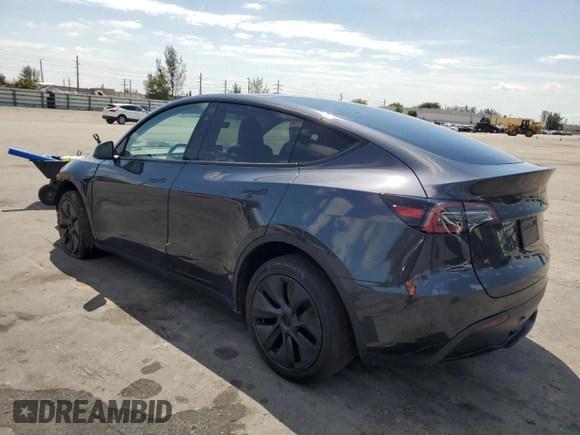 2025 Tesla Model Y Long Range with VIN 7SAYGDED8SF241779, listed as a Copart auction lot 51899205 with 12,409 mi miles and Salvage Title. Bid and sale history available at DreamBid. Image 2.