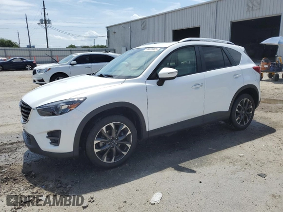2016 Mazda CX-5 Grand Touring z VIN JM3KE2DYXG0731462, wystawiony jako Copart lot #58220465 z przebiegiem 130 033 mil mil oraz Szkoda całkowita • Salvage title. Historia ofert i sprzedaży dostępna na DreamBid. Obrazek 1.