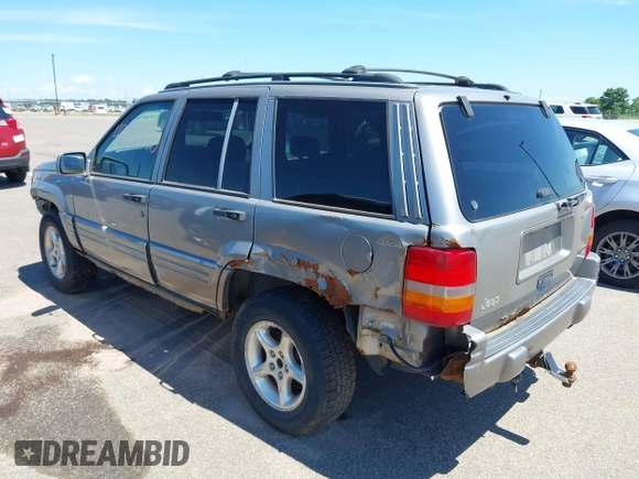 1998 Jeep Grand Cherokee Limited z VIN 1J4GZ88Z4WC328450, wystawiony jako IAAI lot #42652126 z przebiegiem 166 576 mil mil oraz . Historia ofert i sprzedaży dostępna na DreamBid. Obrazek 3.