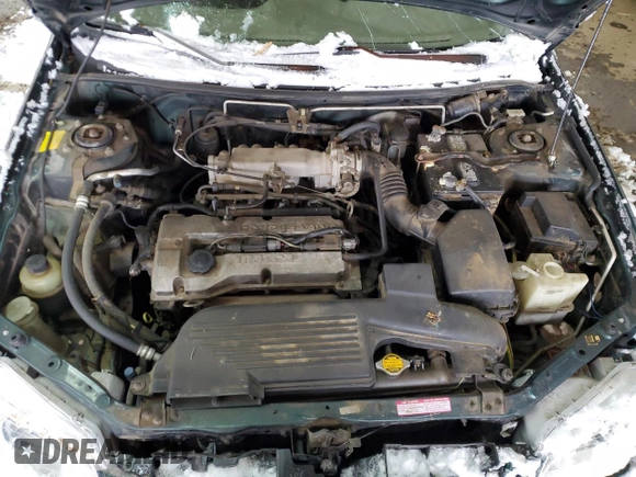 1999 Mazda Protege DX z VIN JM1BJ2220X0108600, wystawiony jako Copart lot #77004894 z przebiegiem 220 836 mil mil oraz Szkoda całkowita • Salvage title. Historia ofert i sprzedaży dostępna na DreamBid. Obrazek 11.