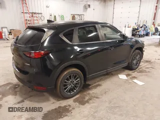 2021 Mazda CX-5 Touring with VIN JM3KFBCM1M1380409, listed as a IAAI auction lot 41677537 with 55,319 mi miles. Bid and sale history available at carsss.com. Image 4.