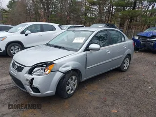 2010 Kia Rio LX with VIN KNADH4A37A6645279, listed as a IAAI auction lot 40856780 with 165,385 mi miles. Bid and sale history available at carsss.com. Image 2.