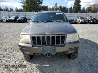 1999 Jeep Grand Cherokee Limited with VIN 1J4GW68S2XC677334, listed as a Copart auction lot 74152054 with 242,220 mi miles and Salvage Title. Bid and sale history available at carsss.com. Image 5.