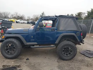 2003 Jeep Wrangler X with VIN 1J4FA39S23P300447, listed as a IAAI auction lot 41791733 with 165,576 mi miles. Bid and sale history available at carsss.com. Image 14.