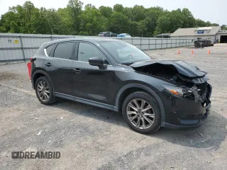 2019 Mazda CX-5 Grand Touring with VIN JM3KFBDM2K0569829, listed as a Copart auction lot 59060965 with 99,359 mi miles and Salvage title. Bid and sale history available at DreamBid. Image 4.