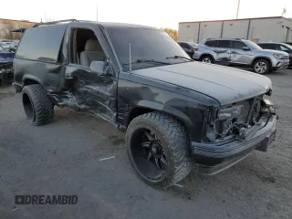1999 Chevrolet Tahoe with VIN 3GNEC18R1XG143882, listed as a Copart auction lot 42177005 with 130,368 mi miles and Salvage title. Bid and sale history available at DreamBid. Image 4.