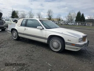 1991 Cadillac Eldorado z VIN 1G6EL13B9MU604115, wystawiony jako Copart lot #52232425 z przebiegiem 95 570 mil mil oraz Szkody całkowita. Historia ofert i sprzedaży dostępna na DreamBid. Obrazek 4.
