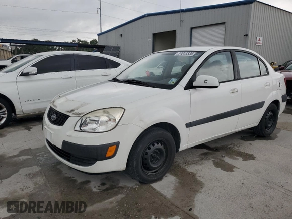 2009 Kia Rio LX with VIN KNADE223X96439445, listed as a Copart auction lot 54619335 with 102,120 mi miles and Salvage Title. Bid and sale history available at DreamBid. Image 1.