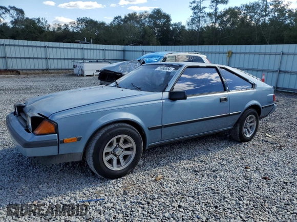 1983 Toyota Celica z VIN JT2RA64L7D6174381, wystawiony jako Copart lot #75986554 z przebiegiem 312 583 mil mil oraz Szkoda całkowita • Salvage title. Historia ofert i sprzedaży dostępna na DreamBid. Obrazek 1.