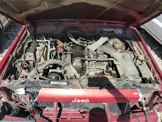 1999 Jeep Cherokee Sport z VIN 1J4FF68S7XL590900, wystawiony jako Copart lot #55098635 z przebiegiem 265 588 mil mil oraz Szkoda całkowita • Salvage title. Historia ofert i sprzedaży dostępna na DreamBid. Obrazek 12.